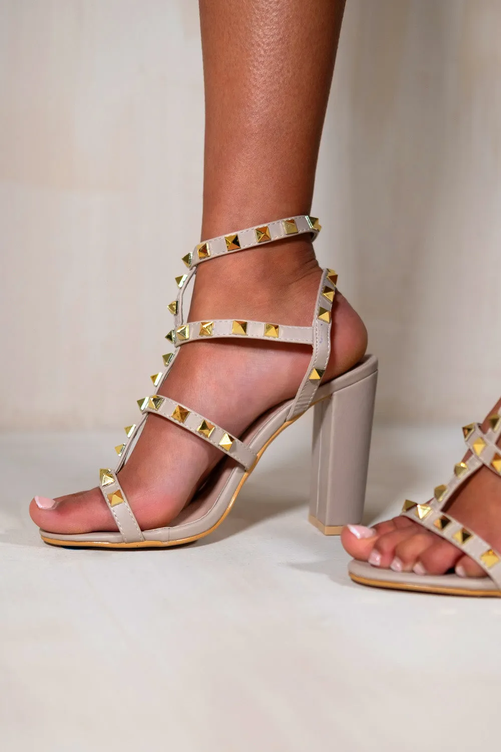 RILEY BLOCK HEEL WITH STUDDED GLADIATOR STRAPS IN NUDE FAUX LEATHER